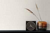Embossed faux grasscloth wallpaper with clock and vase