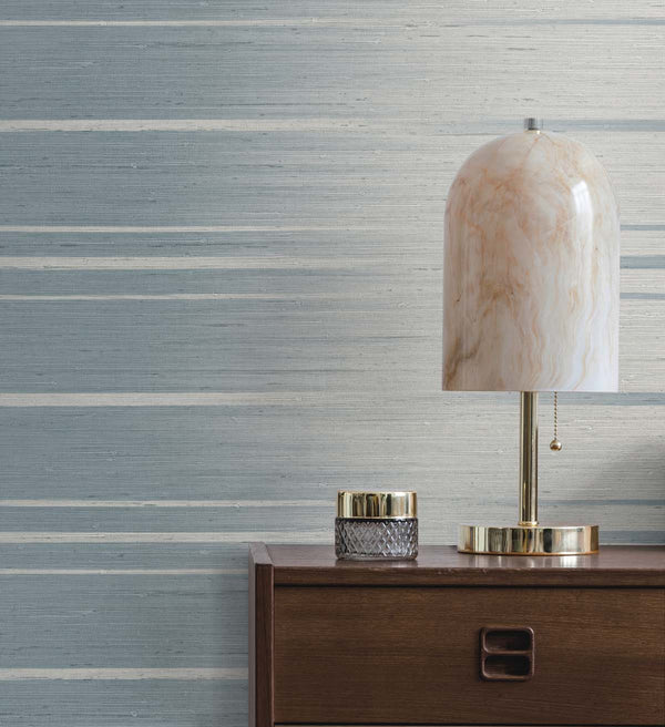 Blue ombre wallpaper in a living room with desk lamp and candle