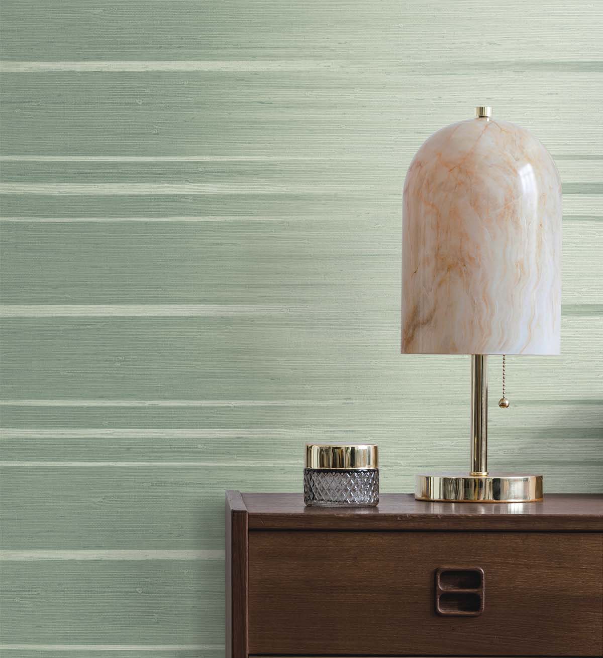 Green grasscloth wallpaper with desk lamp 