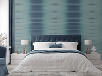 Blue faux grasscloth wallpaper in a bedroom setting
