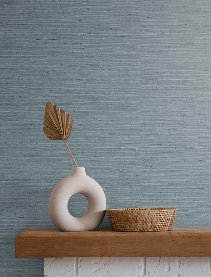 Blue faux grasscloth wallpaper with a vase and wicker basket