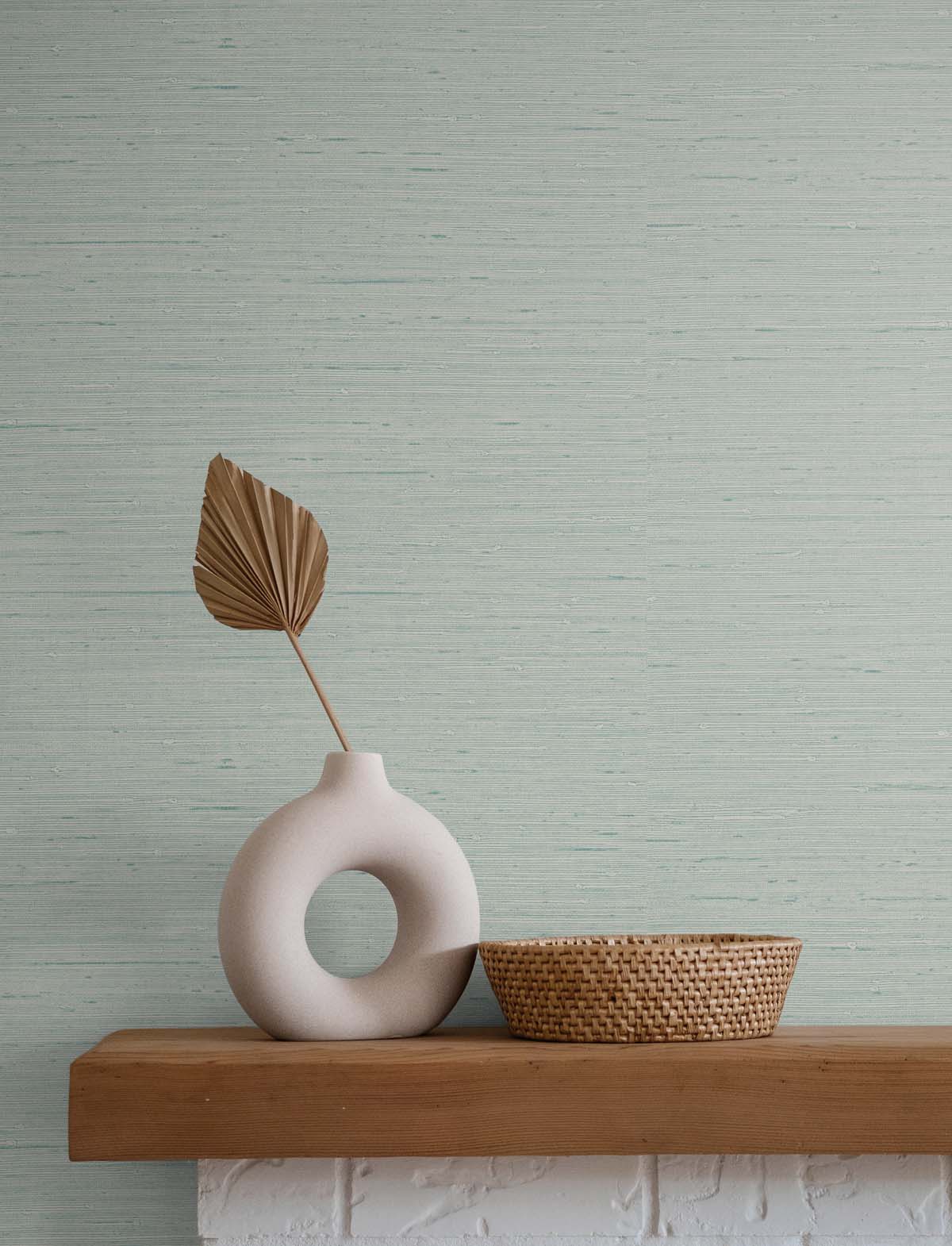 Sea Foam Green Wallpaper with a wicker basket and white vase atop a wooden mantel